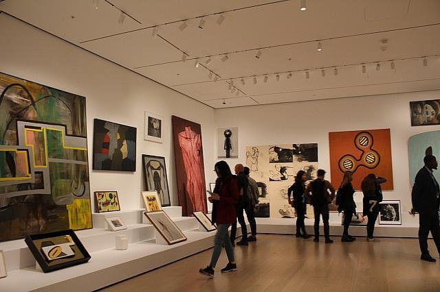 Visitors exploring a contemporary gallery inside MoMA