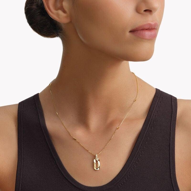 Model wearing a geometric yellow-gold Graff pendant.