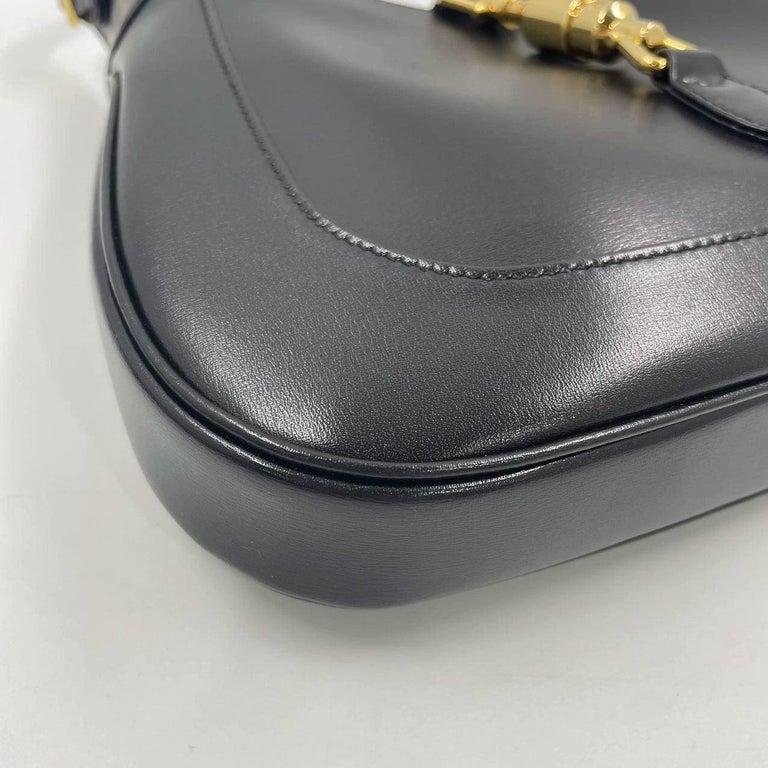 Close-up of corner wear on a black Gucci Jackie 1961 bag.
