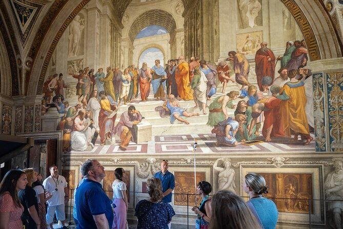 Visitors viewing Raphael’s School of Athens in the Vatican Museums.
