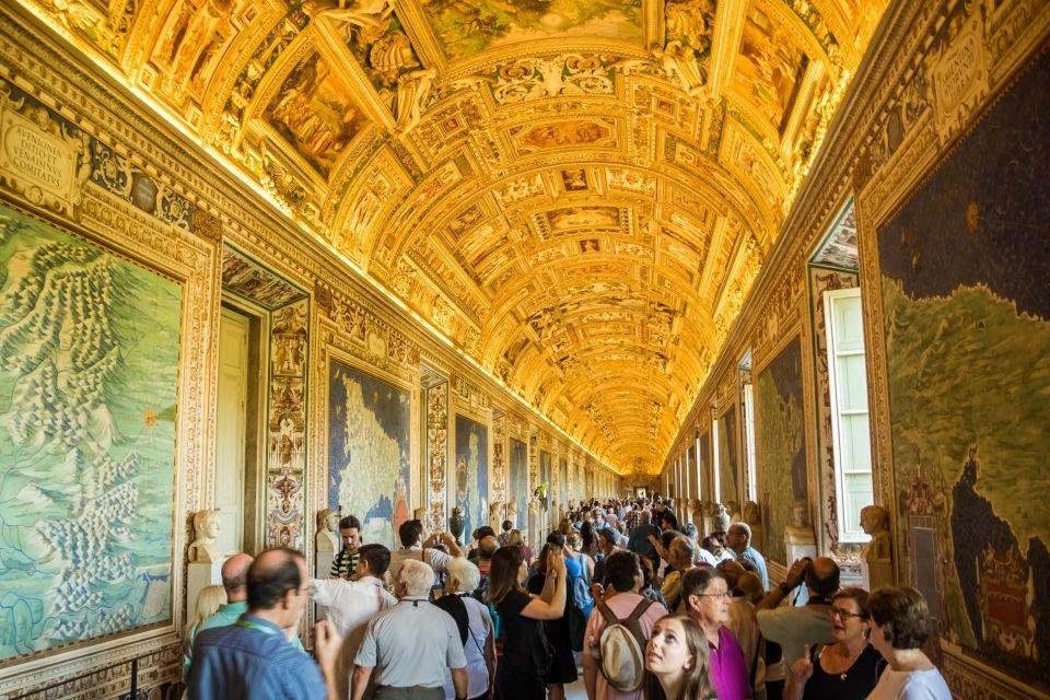 Dense visitor crowds moving through the Gallery of Maps.