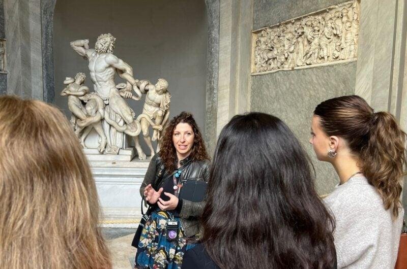 Guide explaining Vatican artworks to a small visitor group.