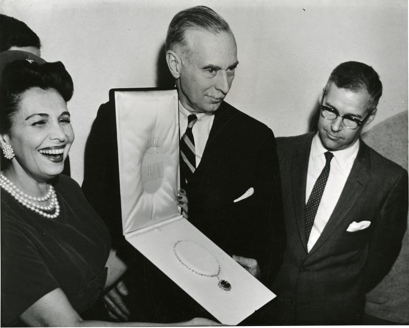 Historical photograph of Harry Winston presenting an important diamond.