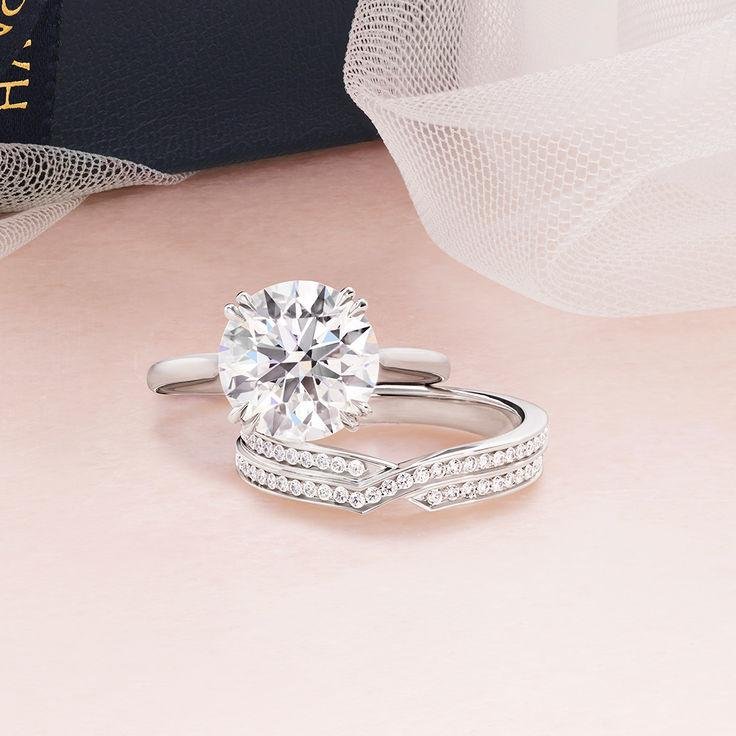 Harry Winston engagement ring paired with a diamond wedding band.