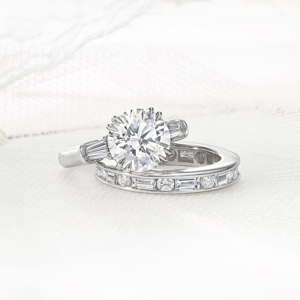 Harry Winston engagement ring and wedding band showing platinum and diamond settings.