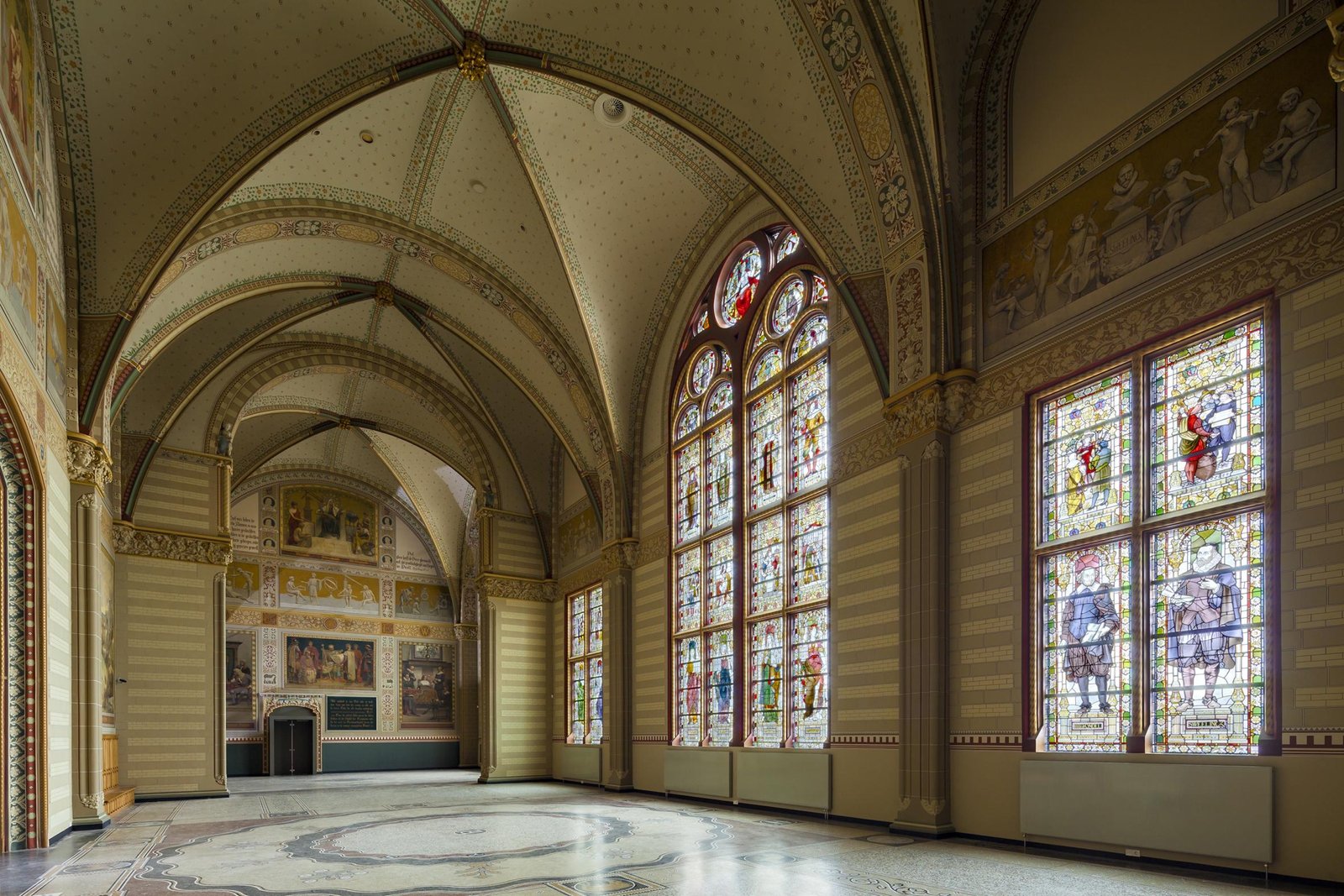 Decorated passage and stained glass inside the Rijksmuseum.