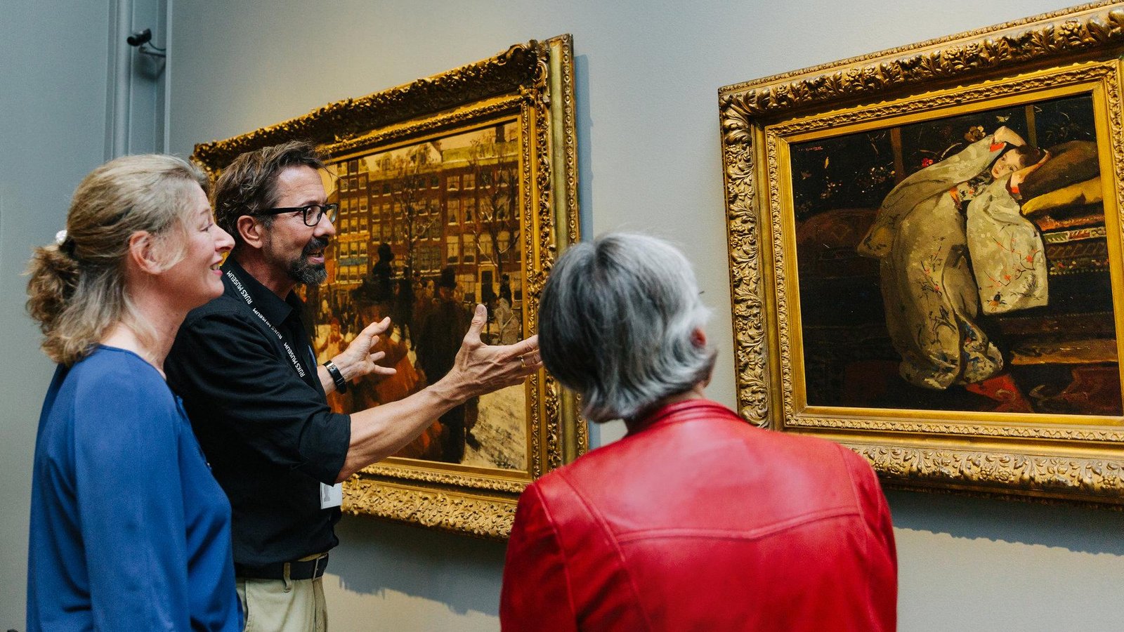 Guide discussing Dutch paintings with Rijksmuseum visitors.