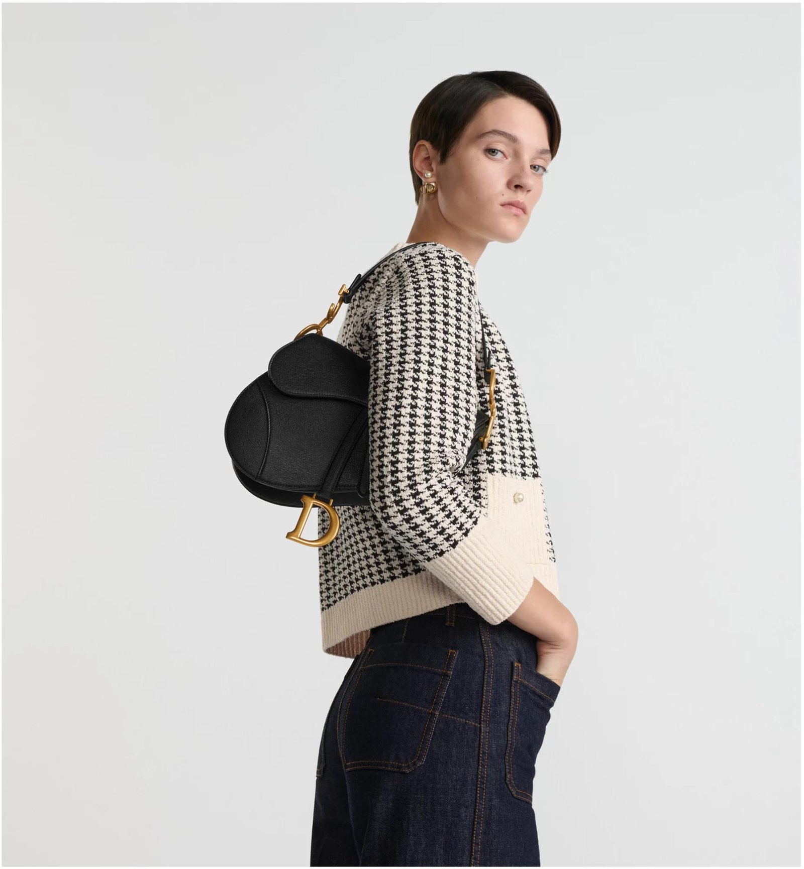 Models carrying Dior Saddle Bags crossbody, over the shoulder and by hand.