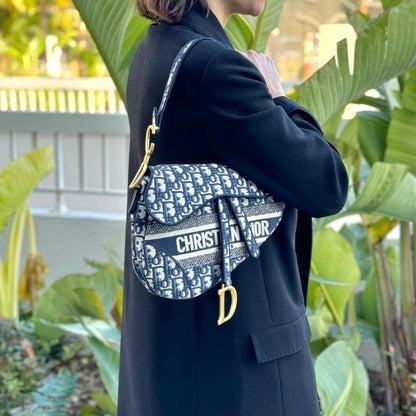 Black Dior Saddle Bag displayed to show its sculptural proportions.