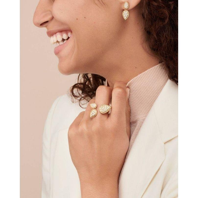Model styling Boucheron Serpent Bohème diamond rings with pale tailoring.