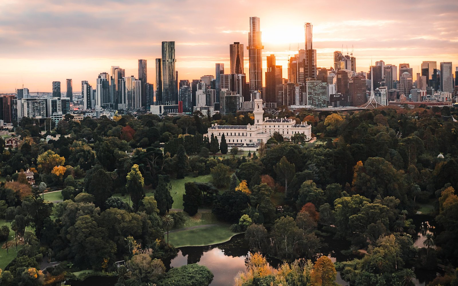 Melbourne Gardens and the city skyline at sunset.