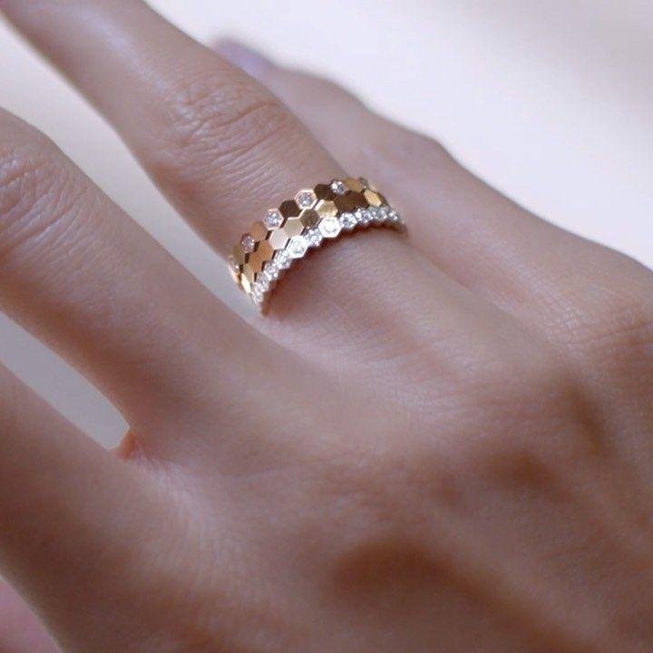 Bee de Chaumet diamond ring worn on a hand.