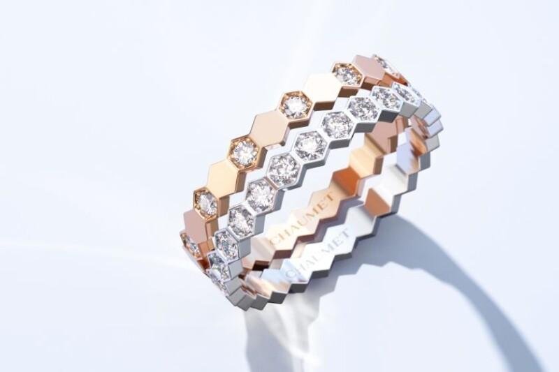 Three Bee de Chaumet rings arranged together on a pale background.