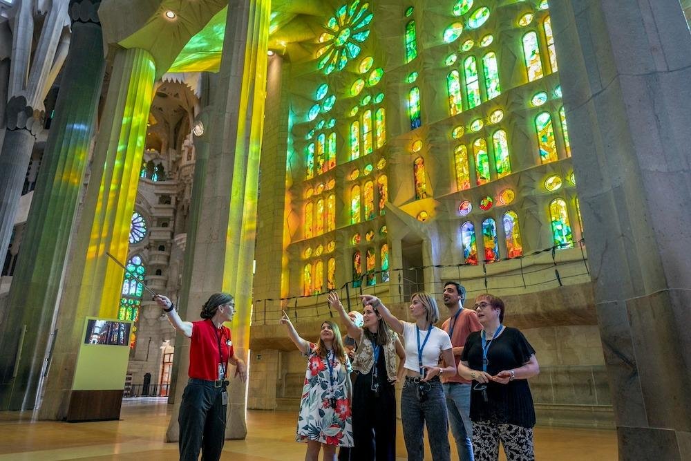 Guide explaining the architecture of the Sagrada Familia to visitors