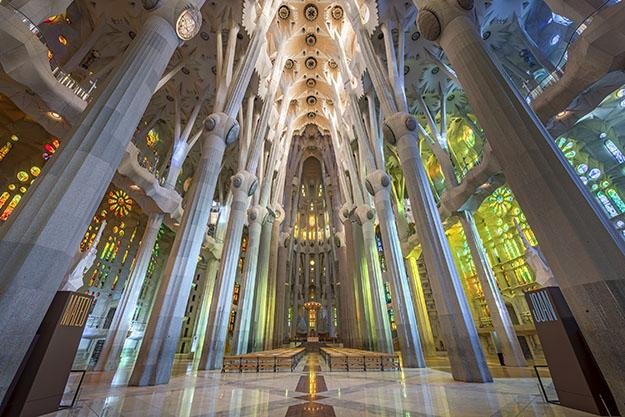 Sunlight illuminating the columns and stained glass of the Sagrada Familia