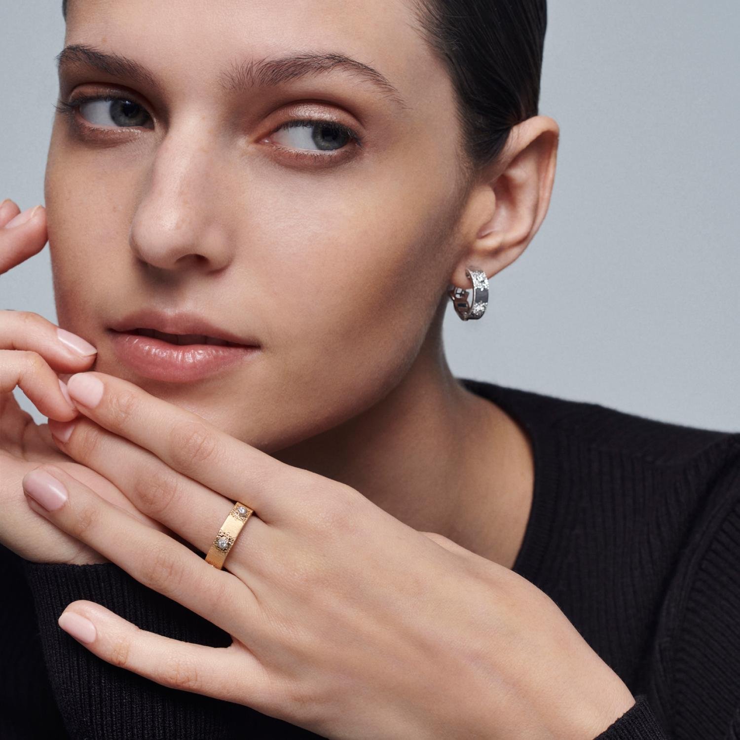 Buccellati rings worn on the hand with elegant neutral clothing