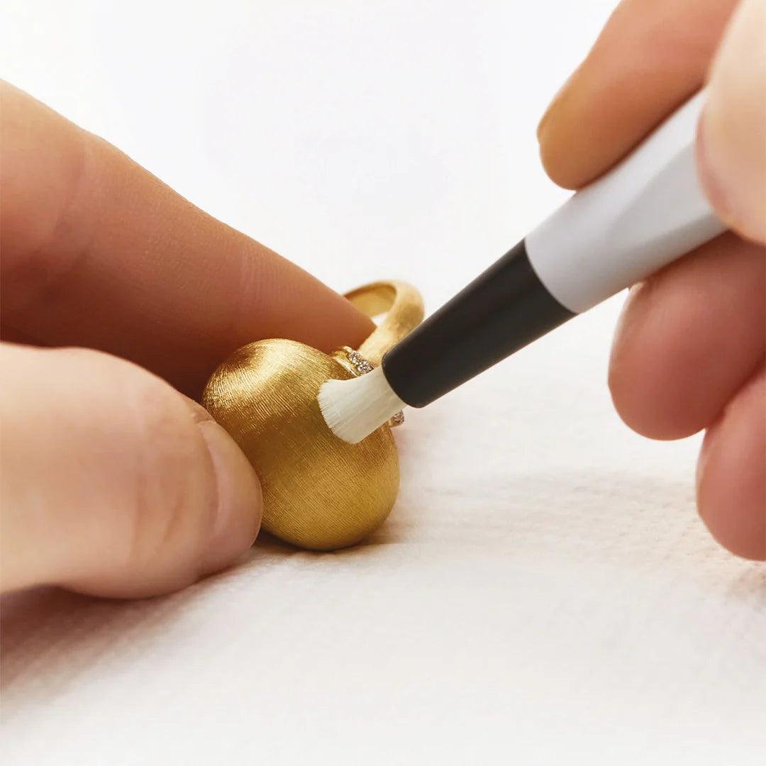 Engraved gold rings being carefully cleaned and stored