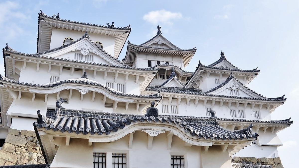 Historic wooden buildings and white walls at Himeji Castle.