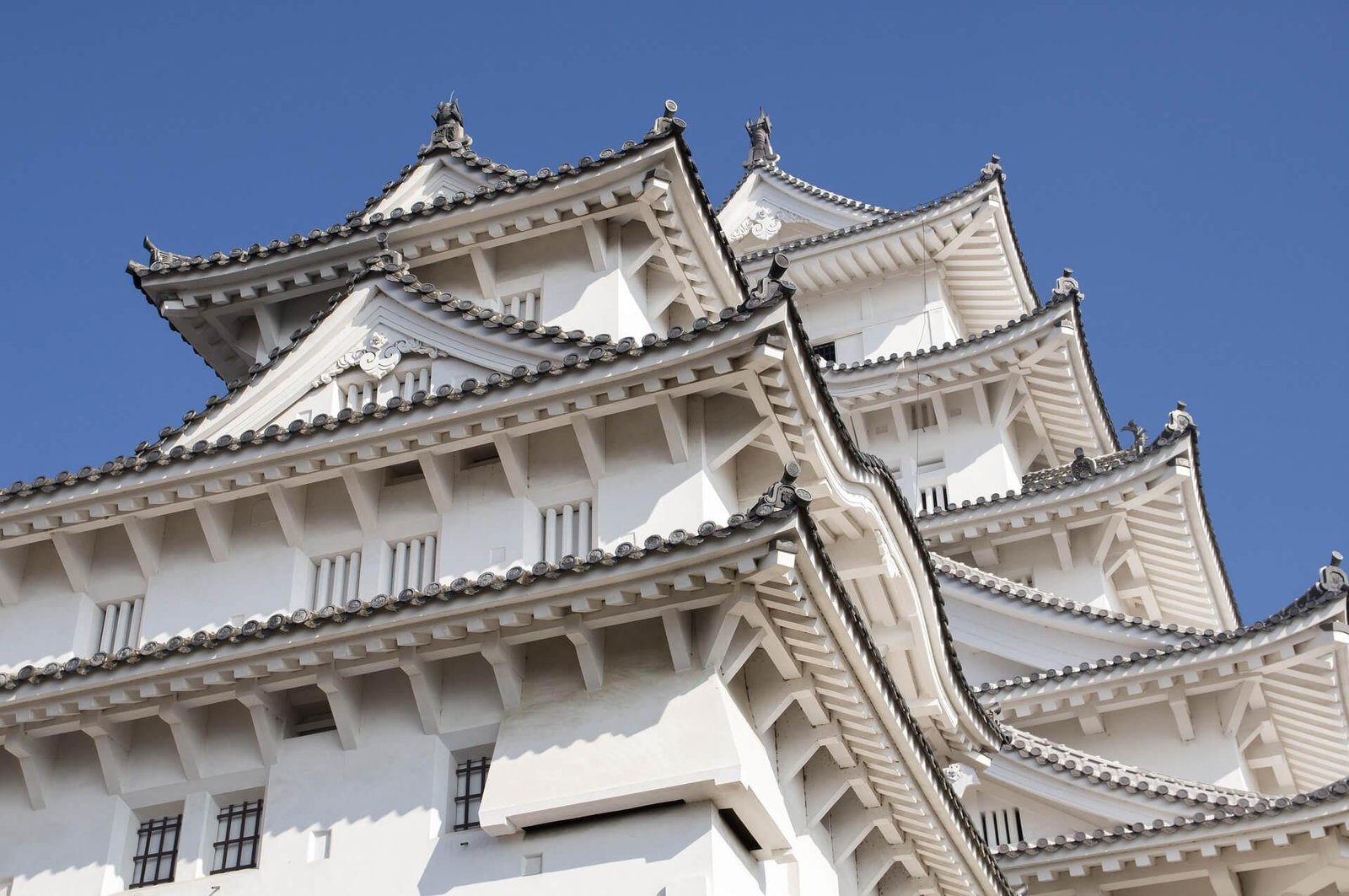 White plaster walls and sweeping rooflines of Himeji Castle.