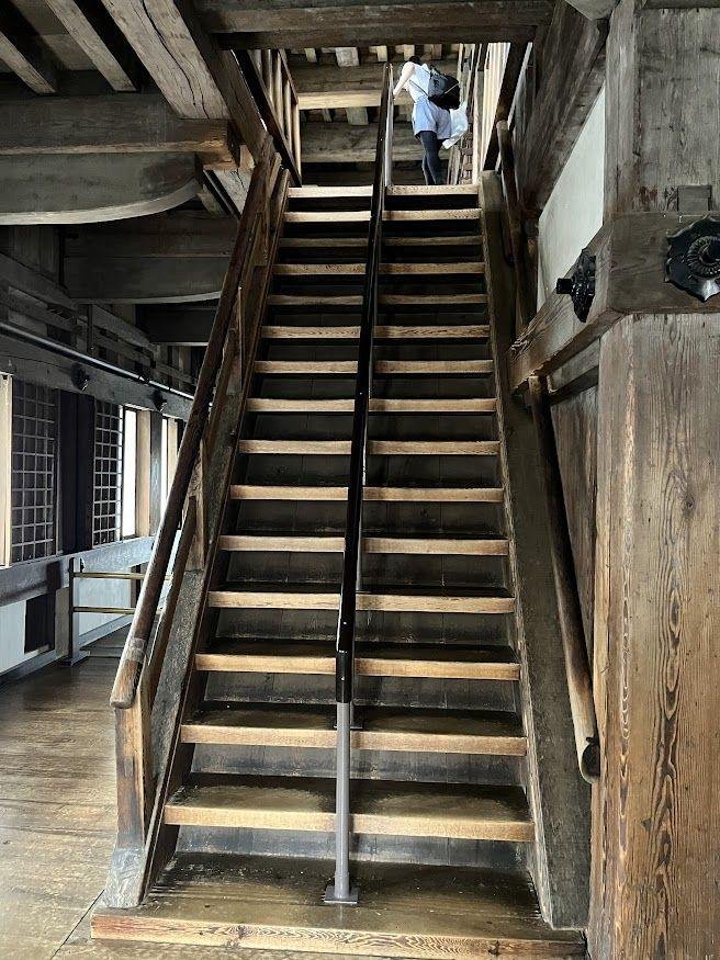 Steep wooden staircase inside Himeji Castle’s main keep.