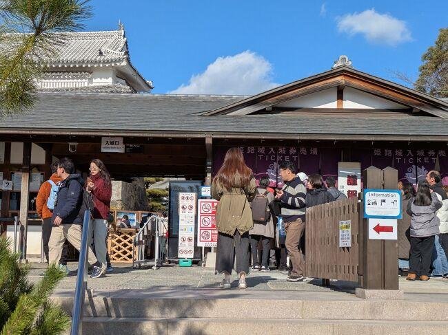 Visitors approaching the entrance and ticket area at Himeji Castle.