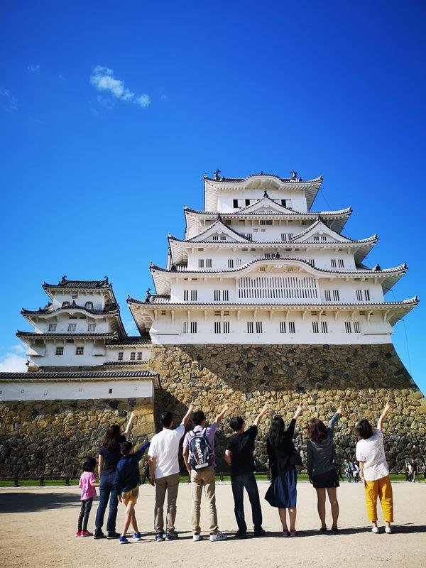Visitors exploring the grounds below Himeji Castle.