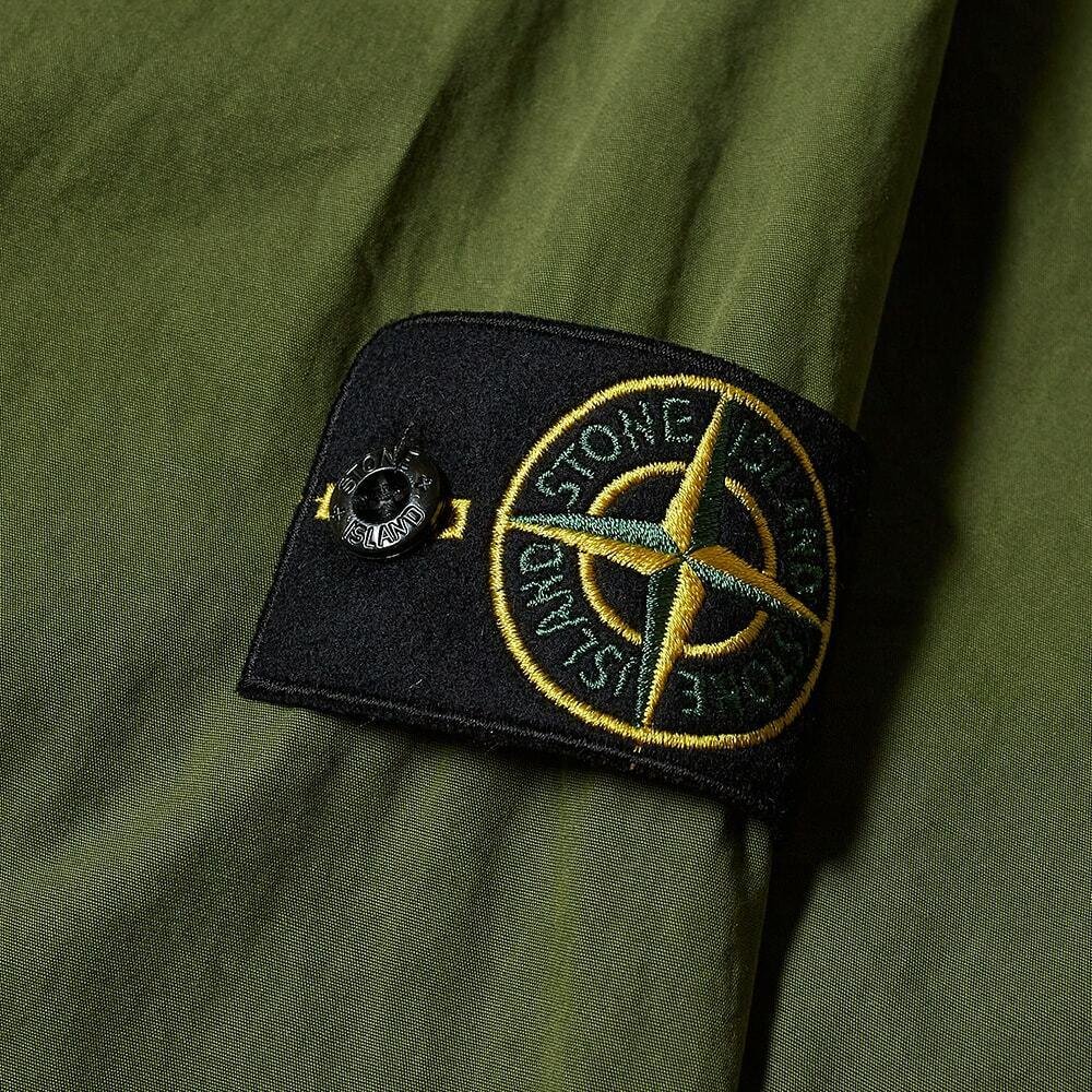 Stone Island compass badge and technical jacket fabric details.