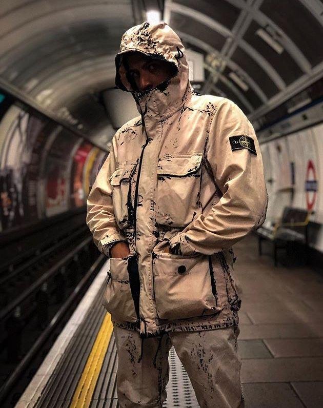 Stone Island jackets worn in rain and cold urban conditions.