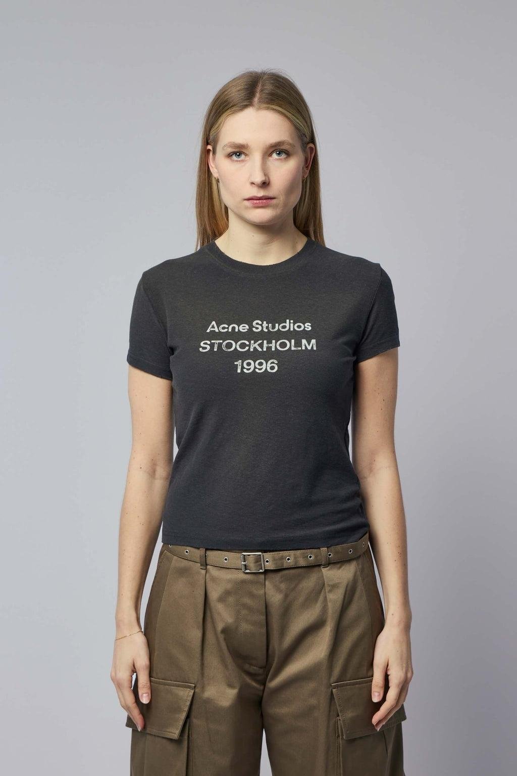 Model wearing the fitted black Acne Studios Stockholm 1996 T-shirt.