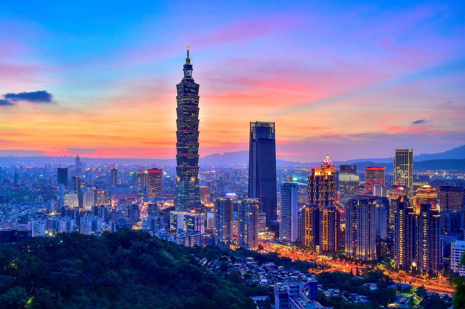 Taipei 101 illuminated above the city at night.