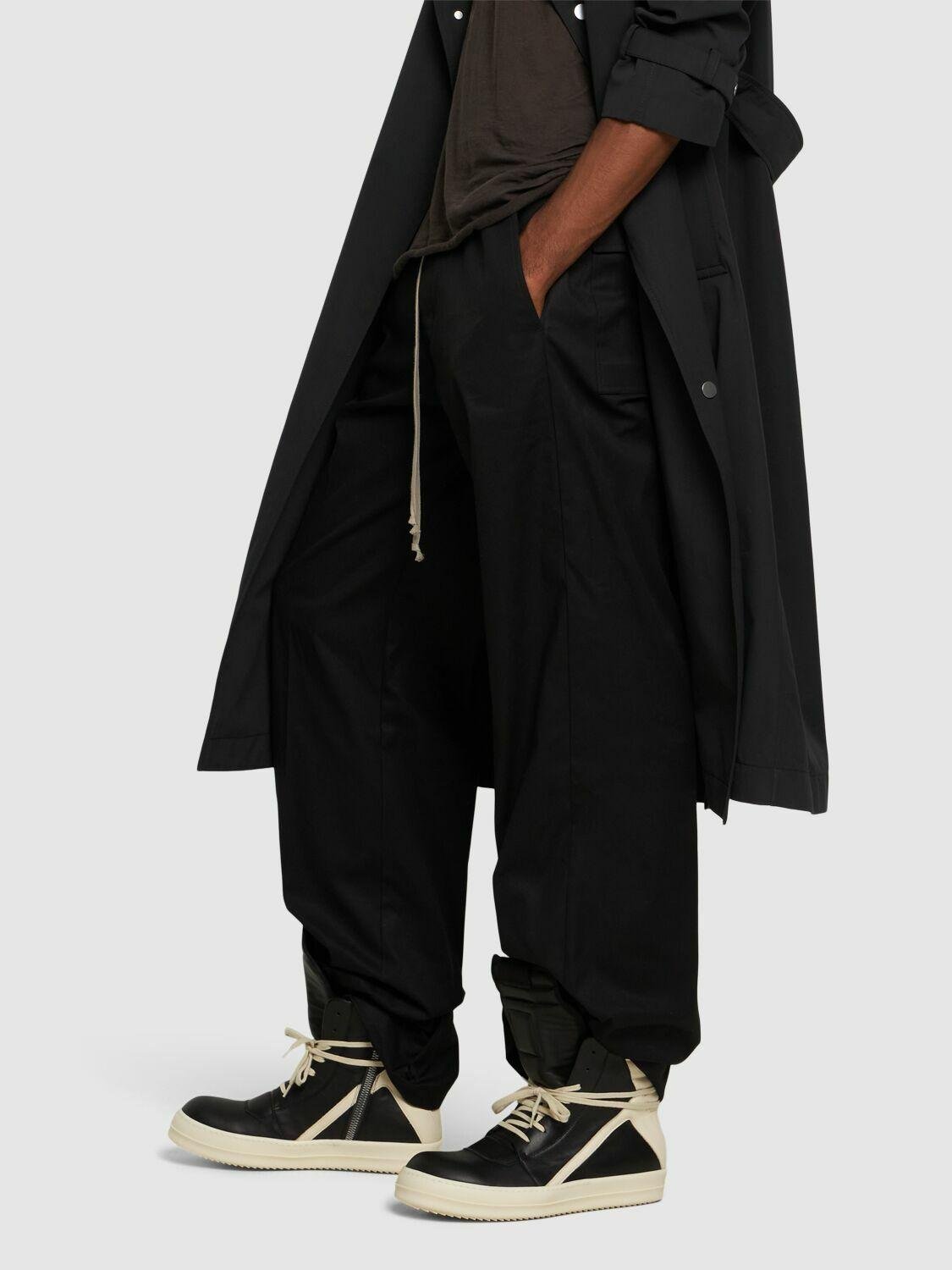 Rick Owens shoes styled with wide trousers and layered clothing.