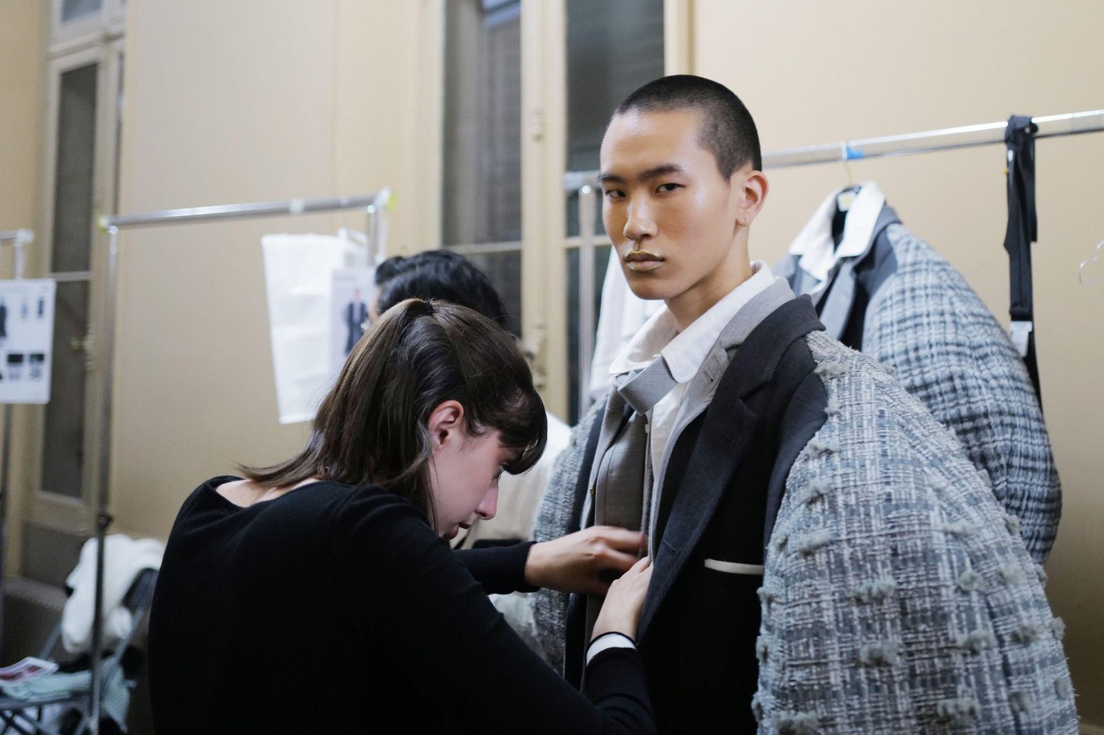 Thom Browne suit shown with its intentionally cropped jacket and trousers.