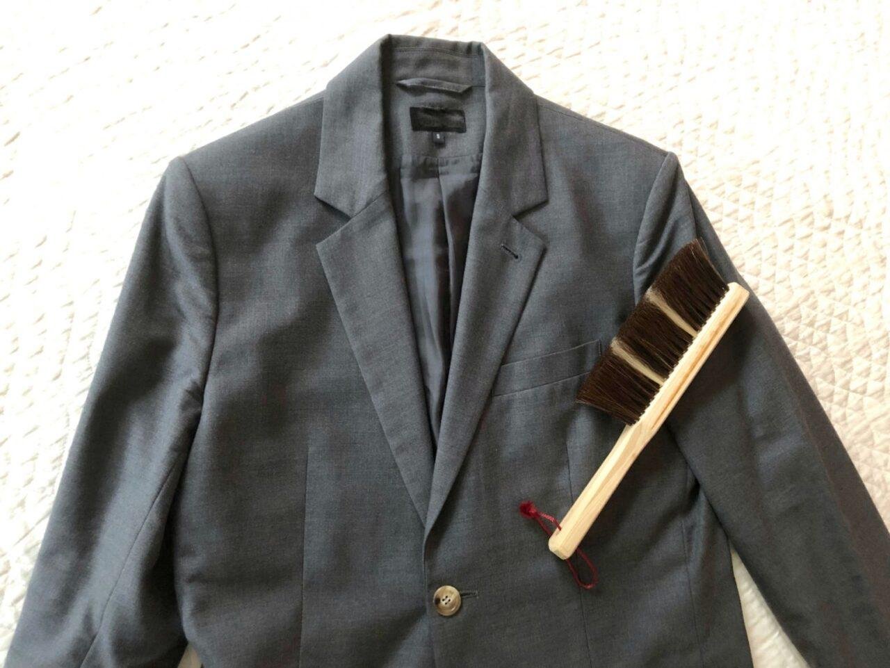 Close-up of Thom Browne wool tailoring requiring careful maintenance.