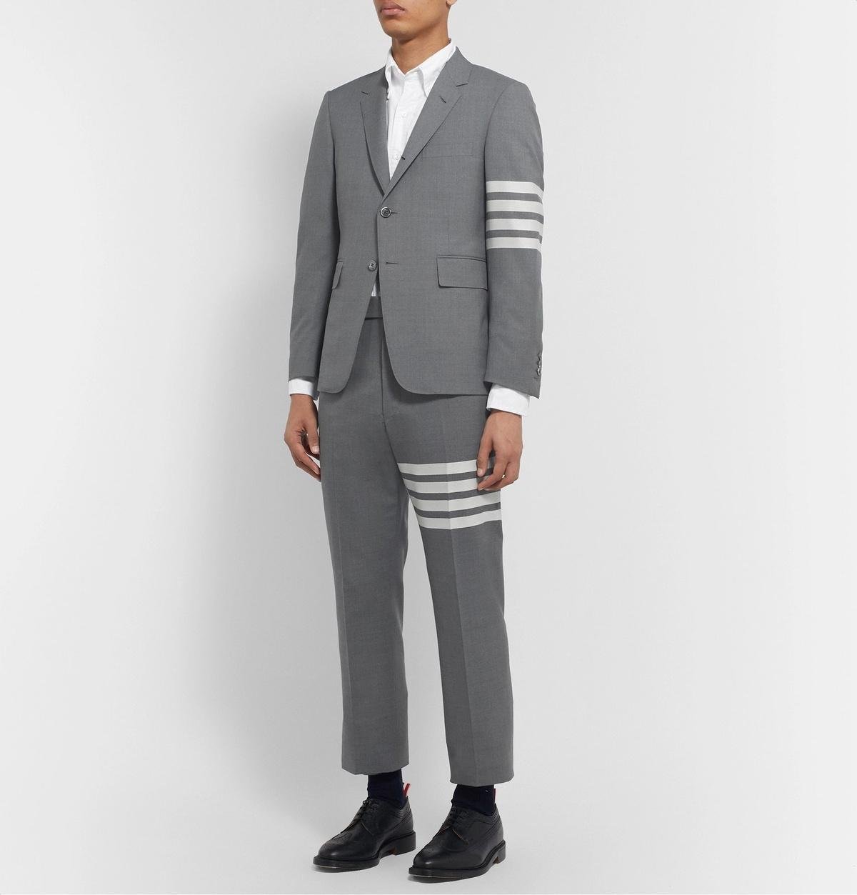 Model wearing the signature grey Thom Browne suit.