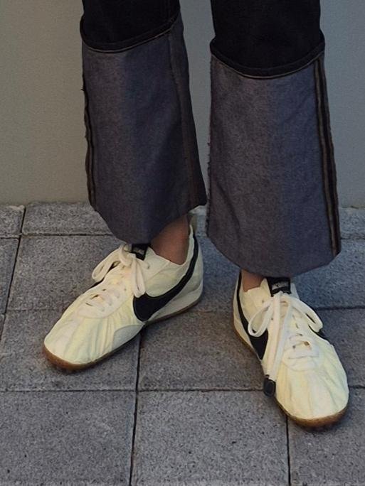 Model styling the Jacquemus x Nike Moon Shoe with relaxed clothing.