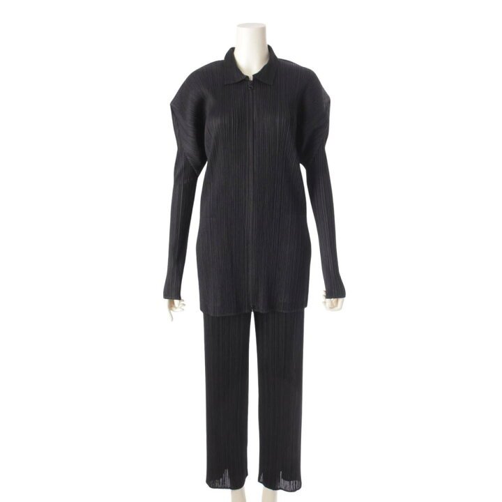 Black Pleats Please Issey Miyake top and trousers displayed against a minimalist background