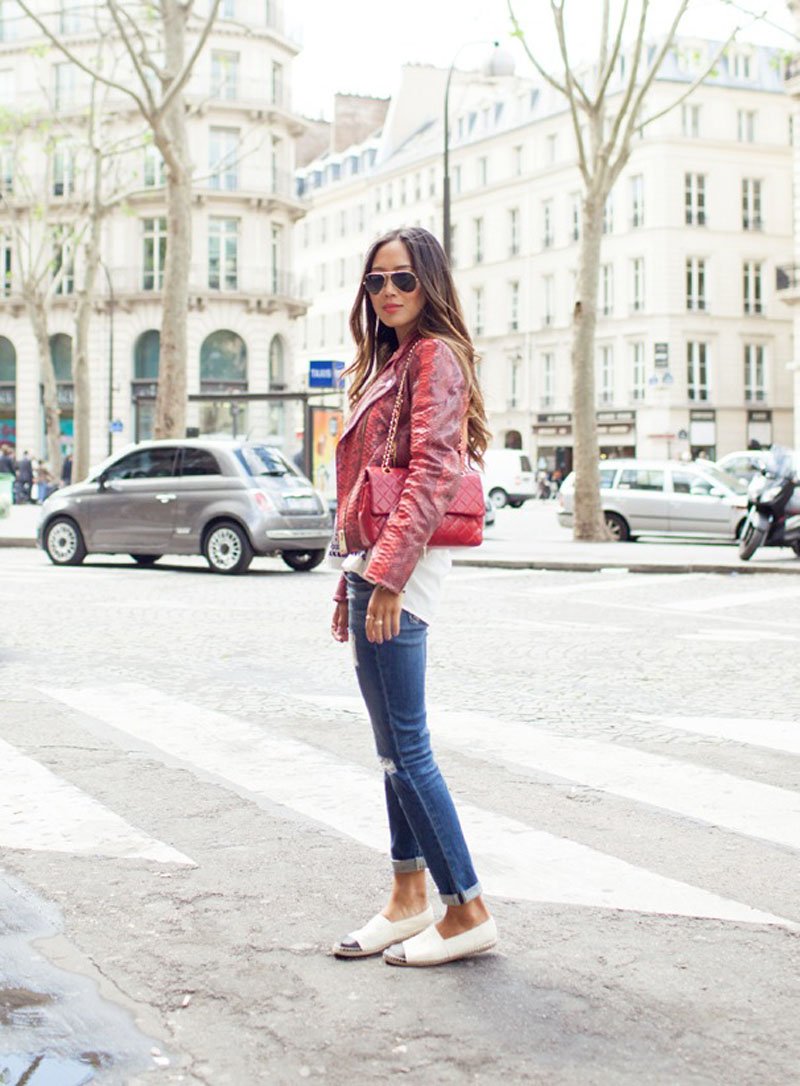 Model wearing white Chanel espadrilles with a red jacket and cuffed jeans.