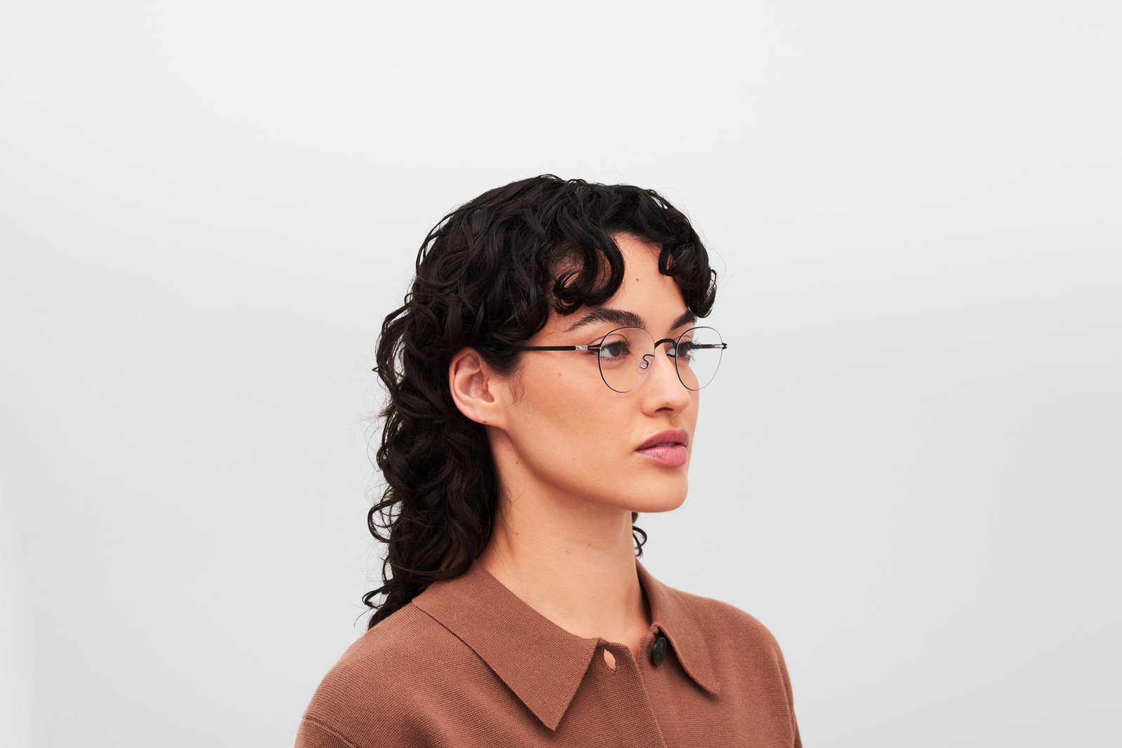 Side view of a model wearing MYKITA MEL optical glasses in Jet Black.