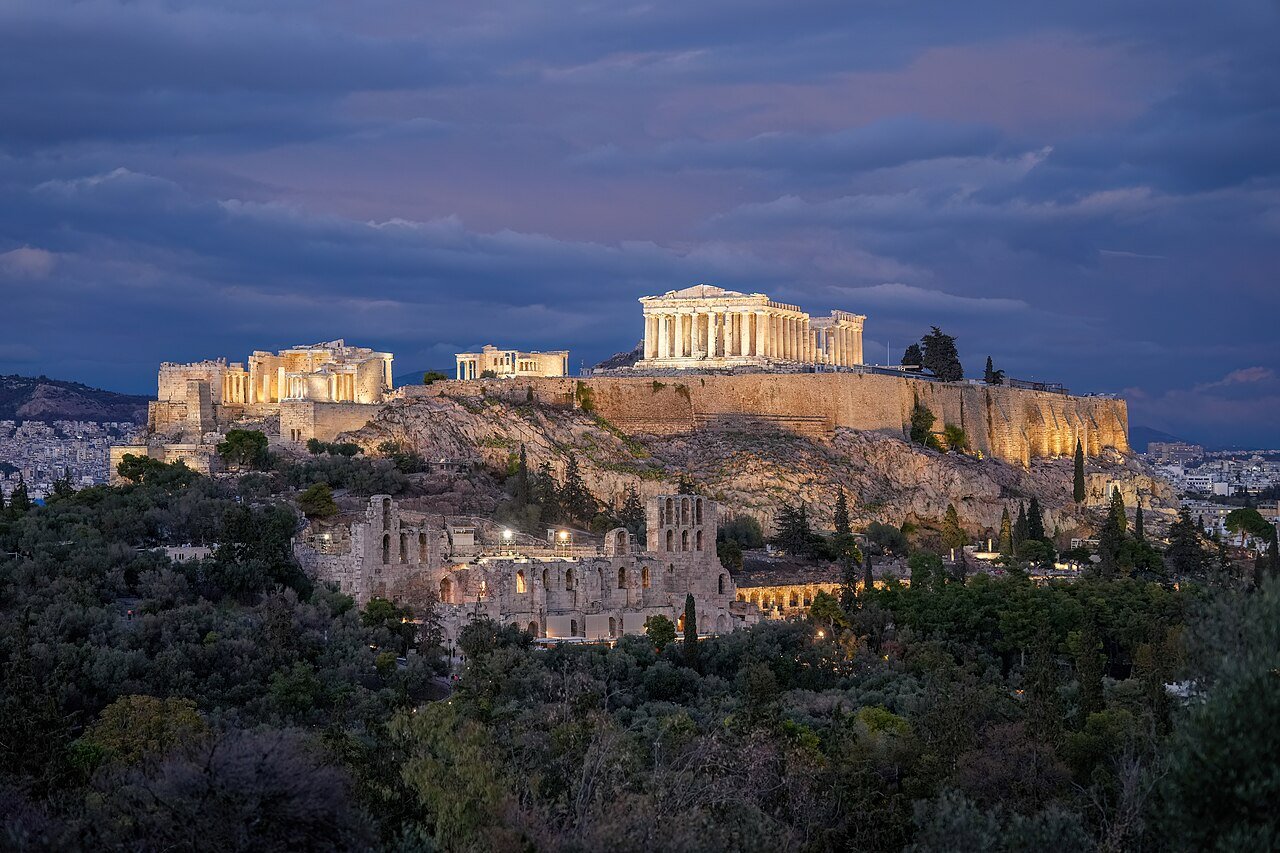 The illuminated Acropolis and Parthenon above Athens at night.