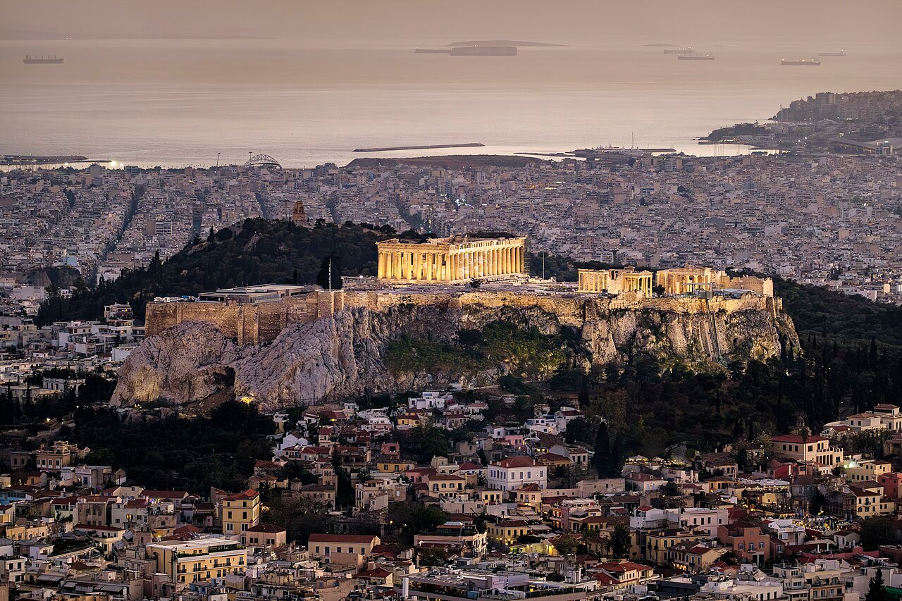 The illuminated Acropolis above Athens at dusk.