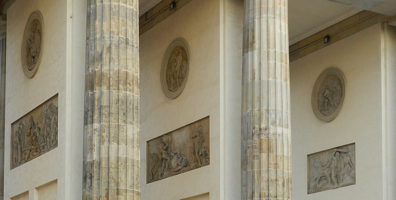 Relief sculptures and column details within Brandenburg Gate’s passageways.