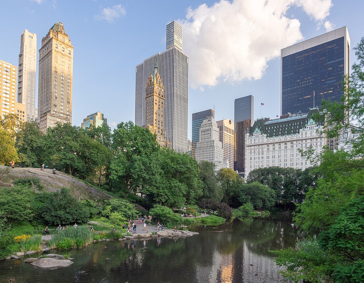 Central Park pond and surrounding Midtown buildings.
