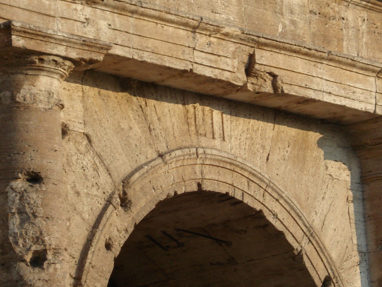 A numbered historic entrance arch at the Colosseum.