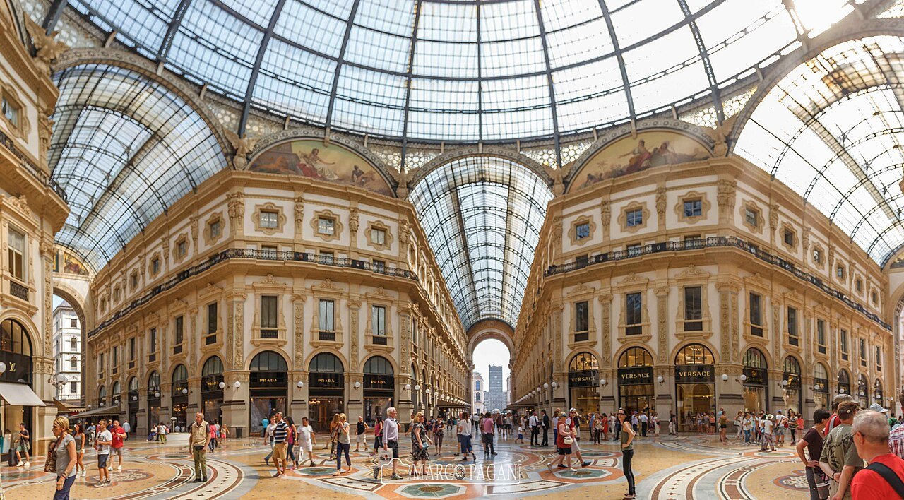 Glass dome and ornate shopping arcades inside Galleria Vittorio Emanuele II in Milan.