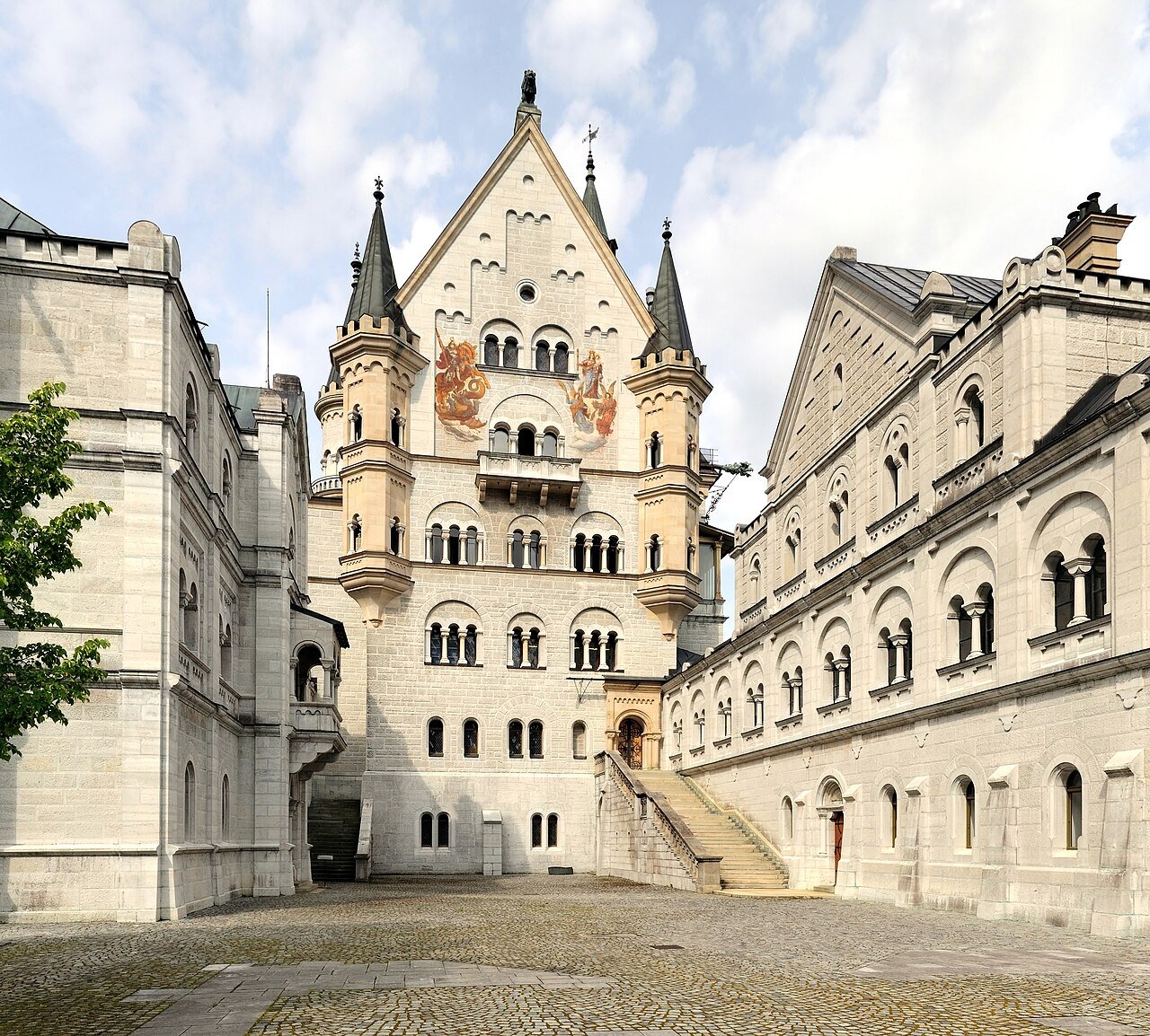 Neuschwanstein Castle courtyard and elaborate pale stone facade.