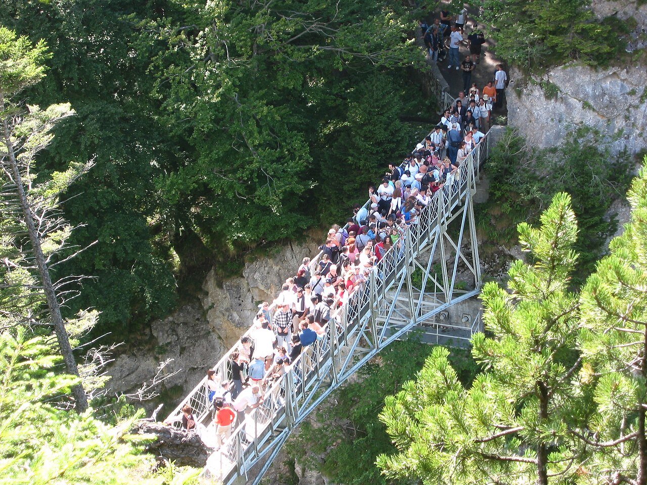 Visitors standing on Marienbrücke above the Pöllat gorge near Neuschwanstein.