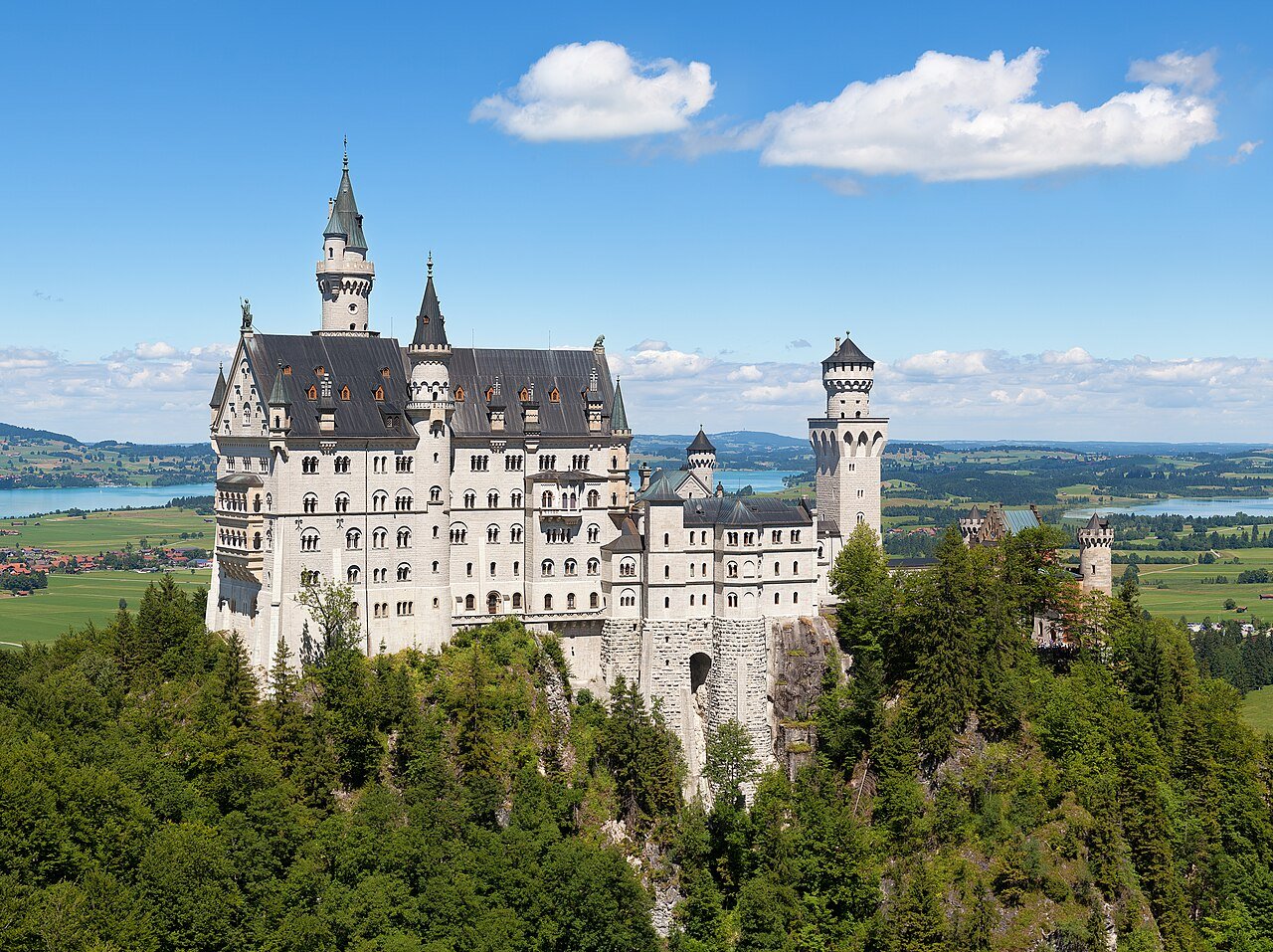 Neuschwanstein Castle rising above forested hills near Schwangau in Bavaria, Germany.