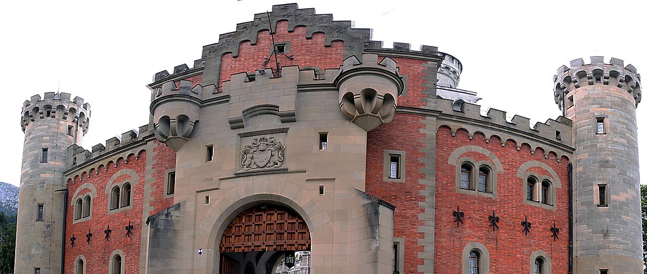 Neuschwanstein Castle’s red-brick gatehouse and arched entrance.