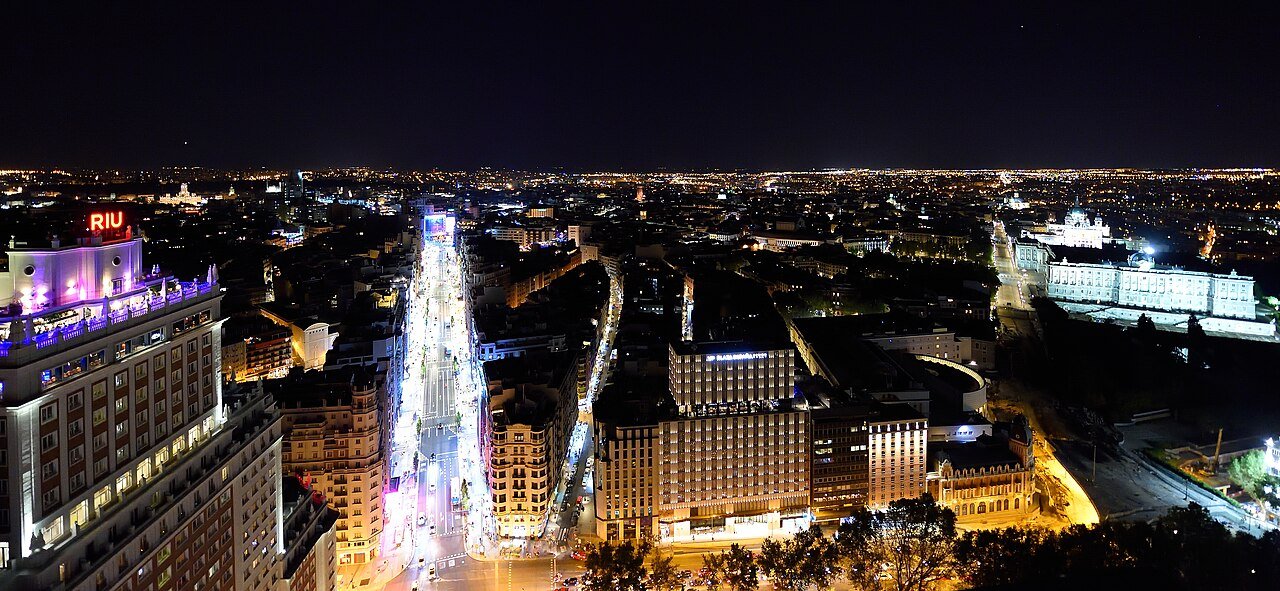 Panoramic night view across Gran Vía and Madrid’s illuminated skyline.