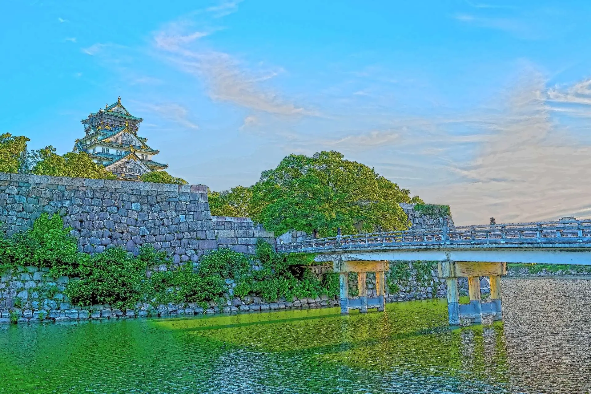 Osaka Castle above its stone fortifications and moat